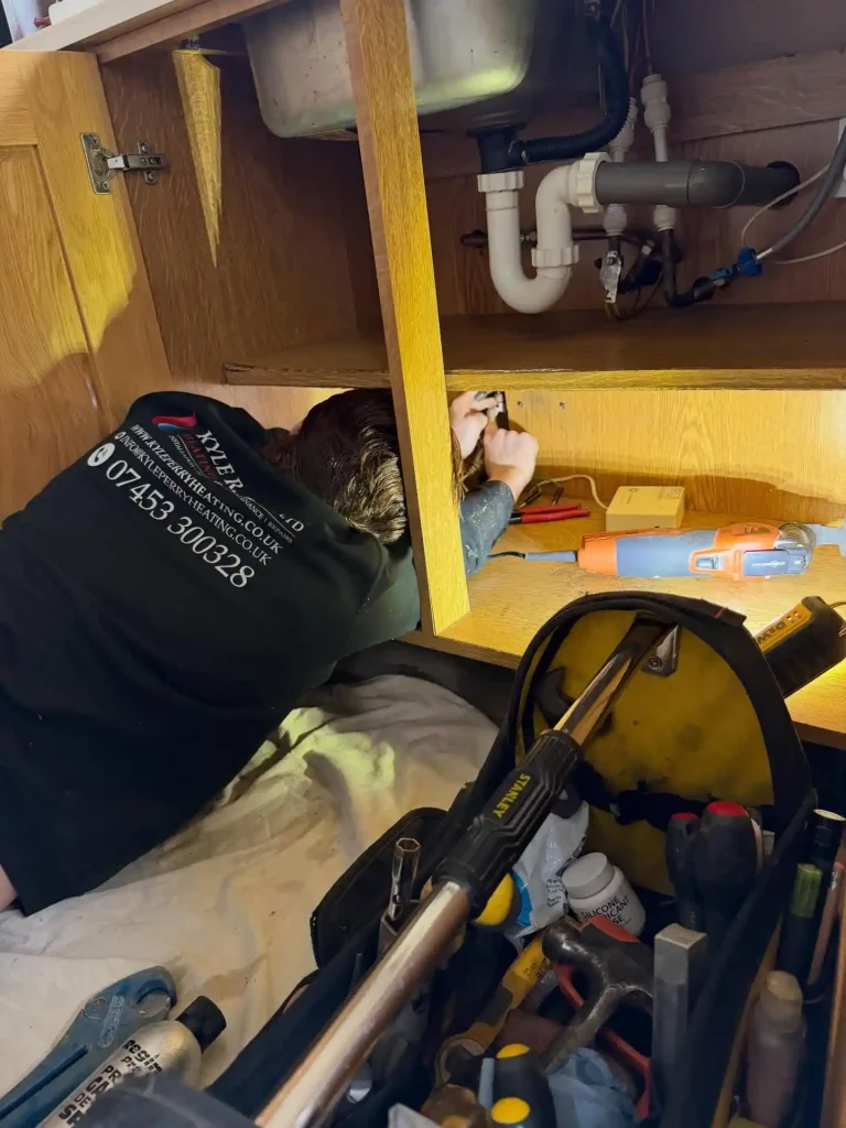 Plumbing engineer carrying out leak detection inspection